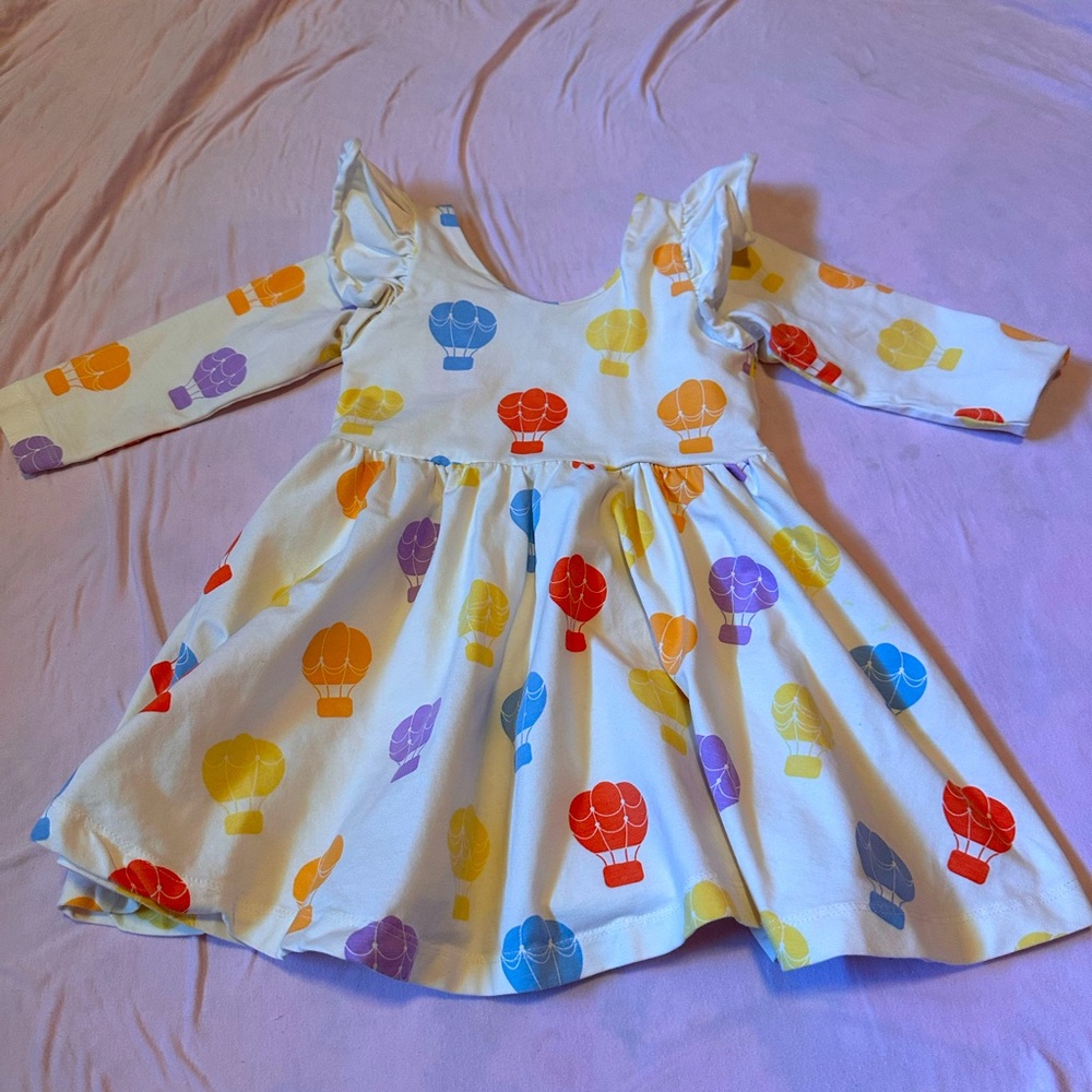 Monica and Andy hot air balloon printed dress. Long sleeved w ruffle at shoulder